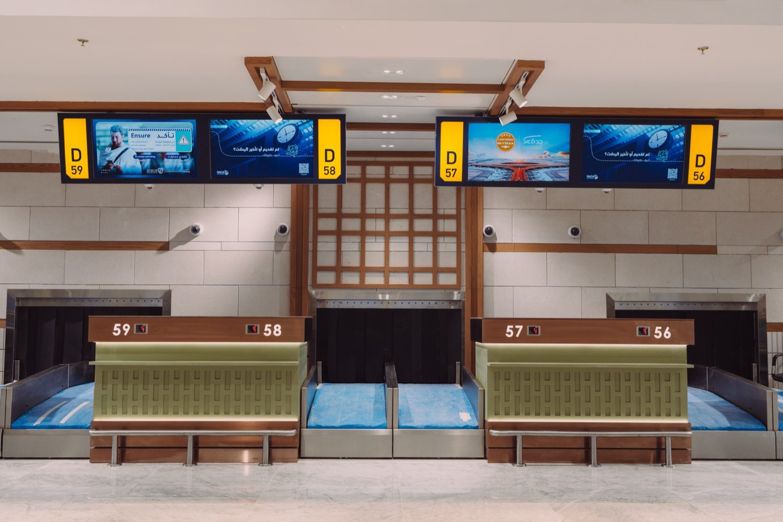Close-up of check-in counters with digital signage above