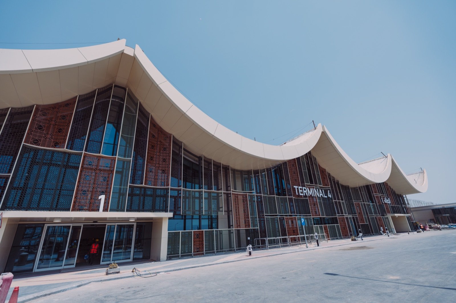 Exterior of the renovated terminal at King Abdulaziz International Airport with its sweeping roofline