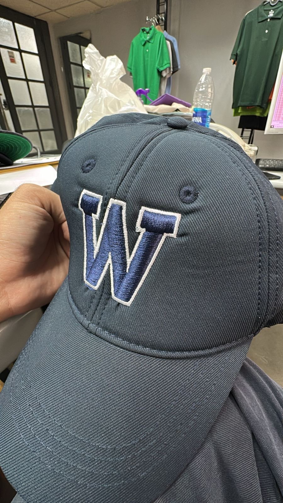 Navy cap embroidered with a guest initial